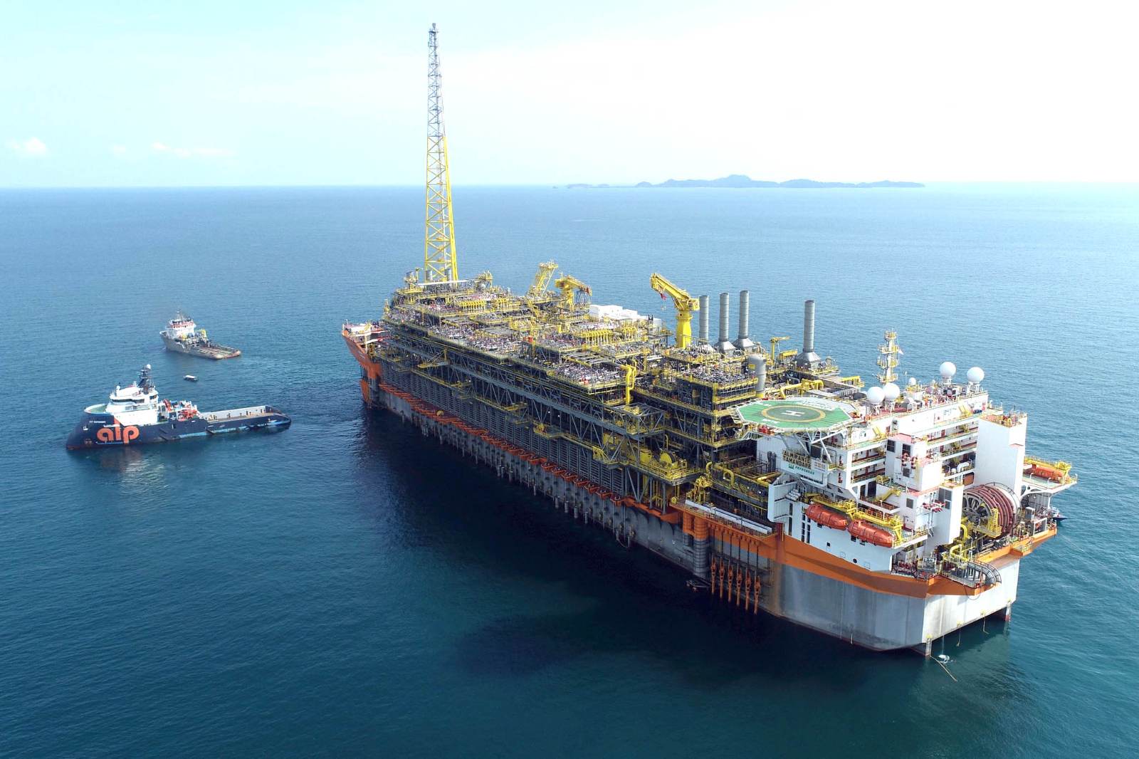 An FPSO on location offshore with support vessels alongside